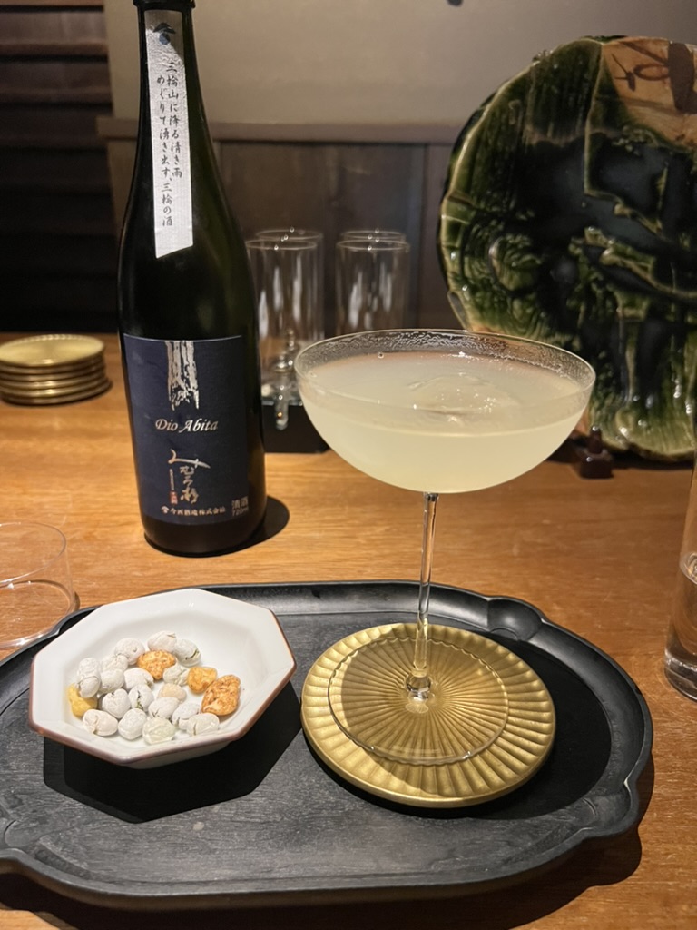 Sake cocktail made with Japanese sake served at a cocktail bar in Tokyo with small bar snacks.