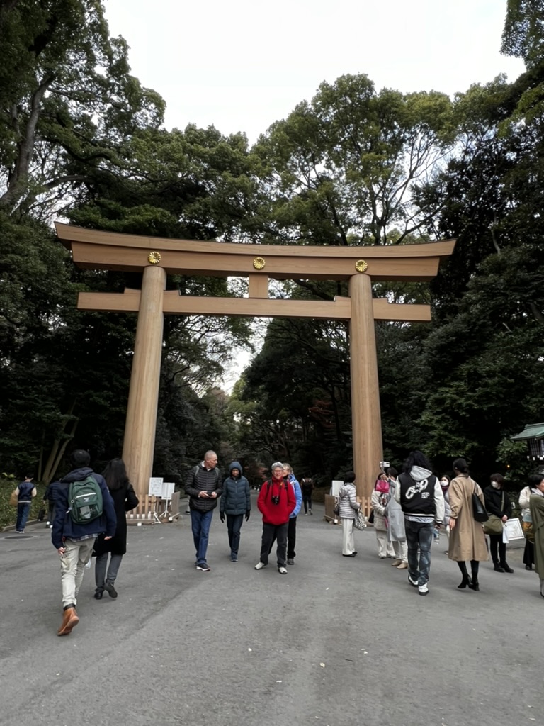 Massive wooden torii gate marking the entrance to Meiji Shrine, one of the most famous Shinto shrines in Tokyo.