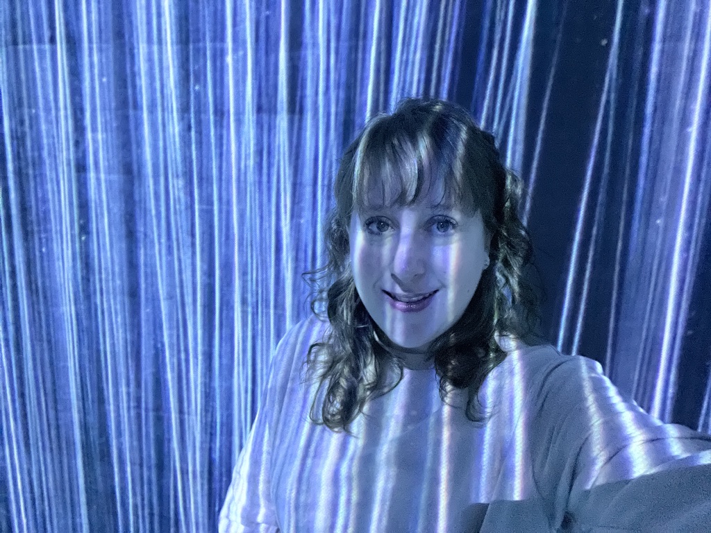 Solo traveler inside immersive light installation at teamLab Borderless in Tokyo.