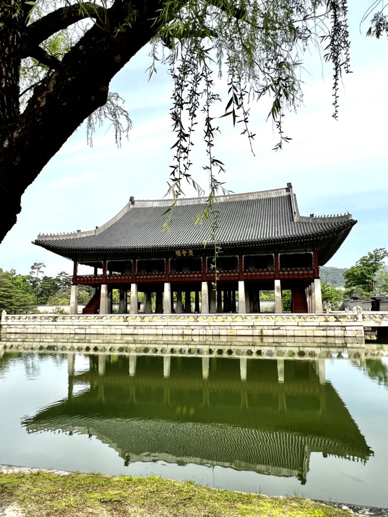 Solo female traveler exploring Seoul, visiting popular landmarks like Gyeongbokgung Palace, enjoying street food, and experiencing vibrant city life during a one-week trip in Seou