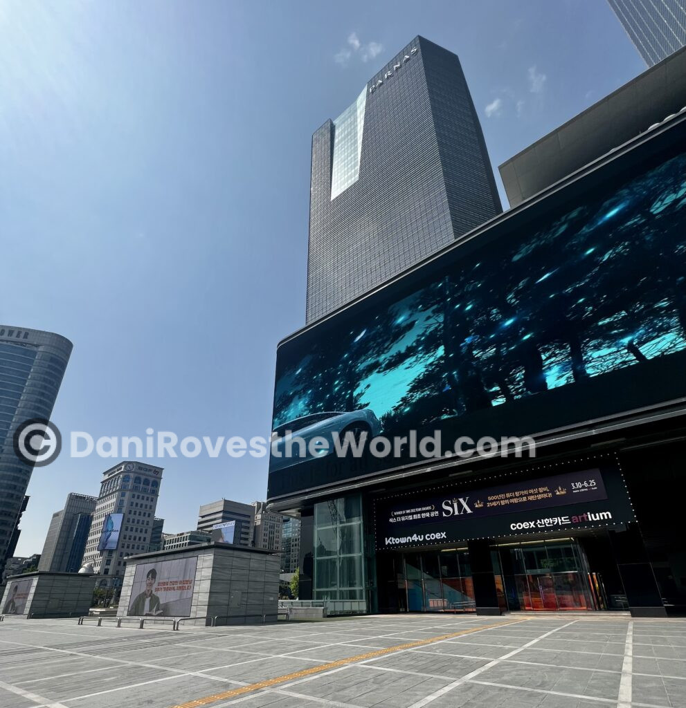 Skyscrapers and digital screens in K-Pop Plaza at COEX, Gangnam, Seoul, showcasing the district's modernity and status as a hub for business, entertainment, and tourism