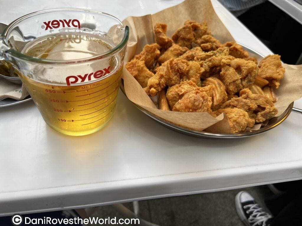 Crispy Korean fried chicken served with a glass of beer, showcasing the popular 'chimaek' combination, a must try foods in Seoul.
