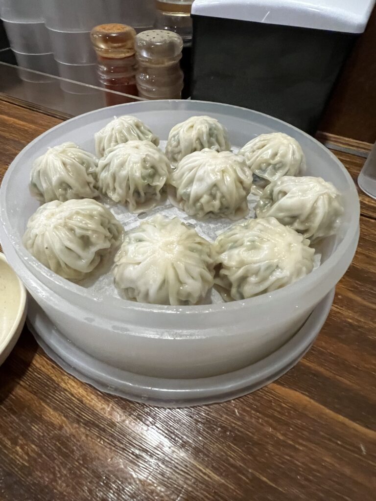 A delicious serving of steamed Michelin dumplings from Myeongdong Kyoja in Seoul, known for their soft texture and flavorful filling