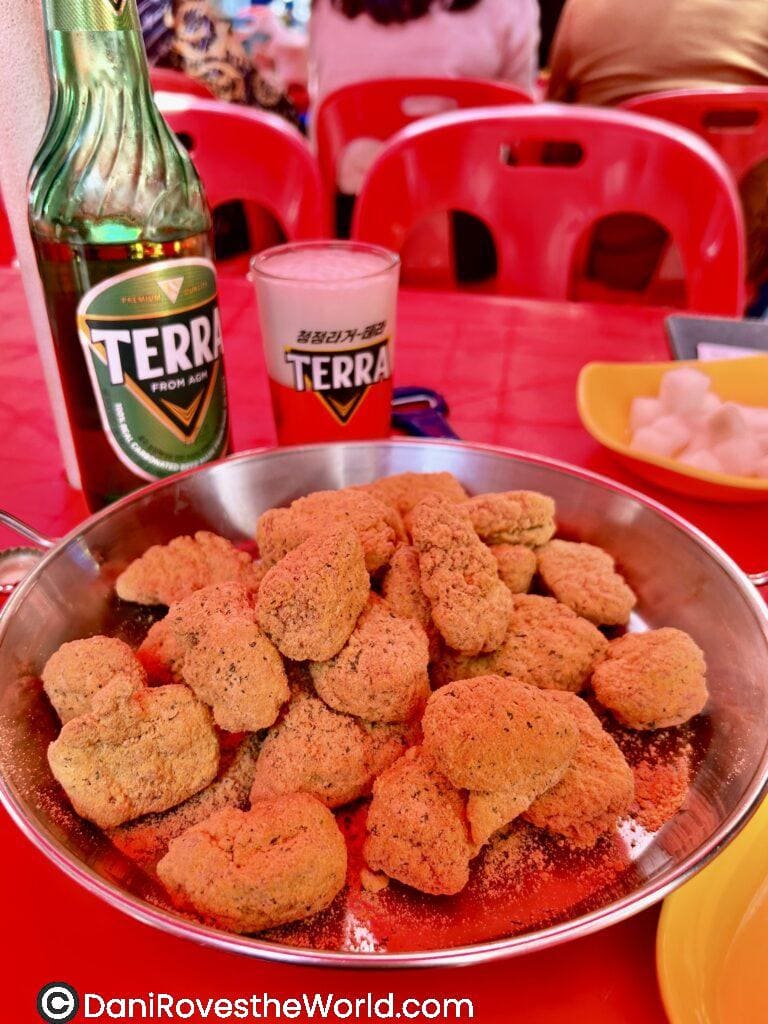 A plate of crispy Korean fried chicken paired with Terra beer at Daily Beer, showcasing one of the must try foods in Seoul.