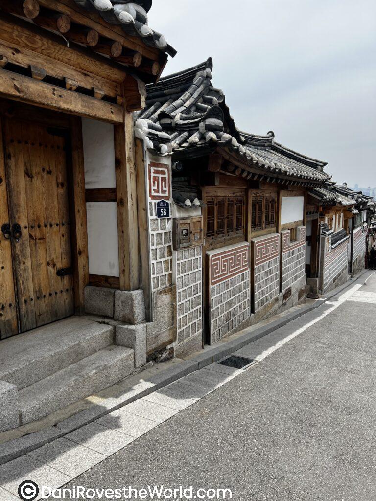 A quiet alleyway featuring traditional hanok houses in Seoul, showcasing the city's historical architecture. Ideal for solo female travelers seeking a cultural experience