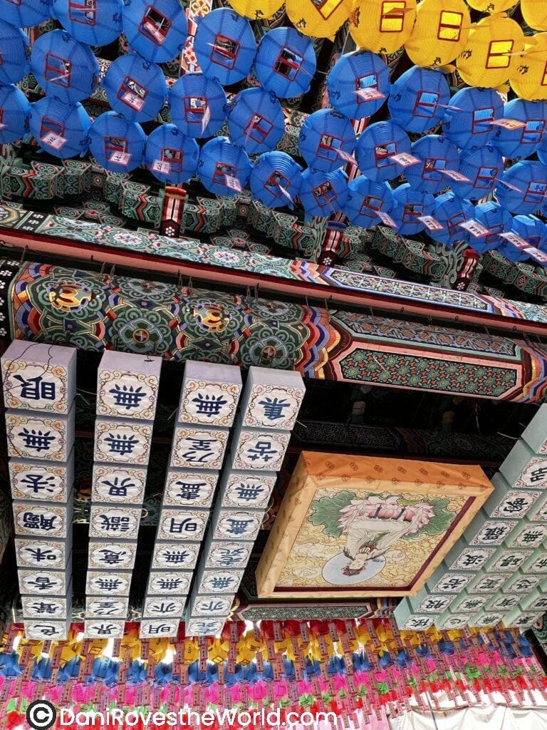 Ceiling of Jogyesa Temple covered with vibrant lanterns and detailed Korean characters, showcasing the artistic and cultural richness of the site.