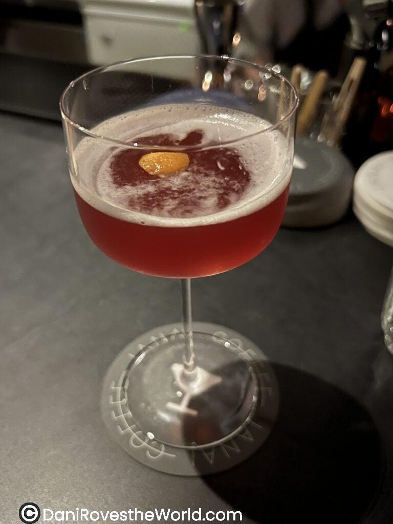 Amber cocktail with an orange in the glass