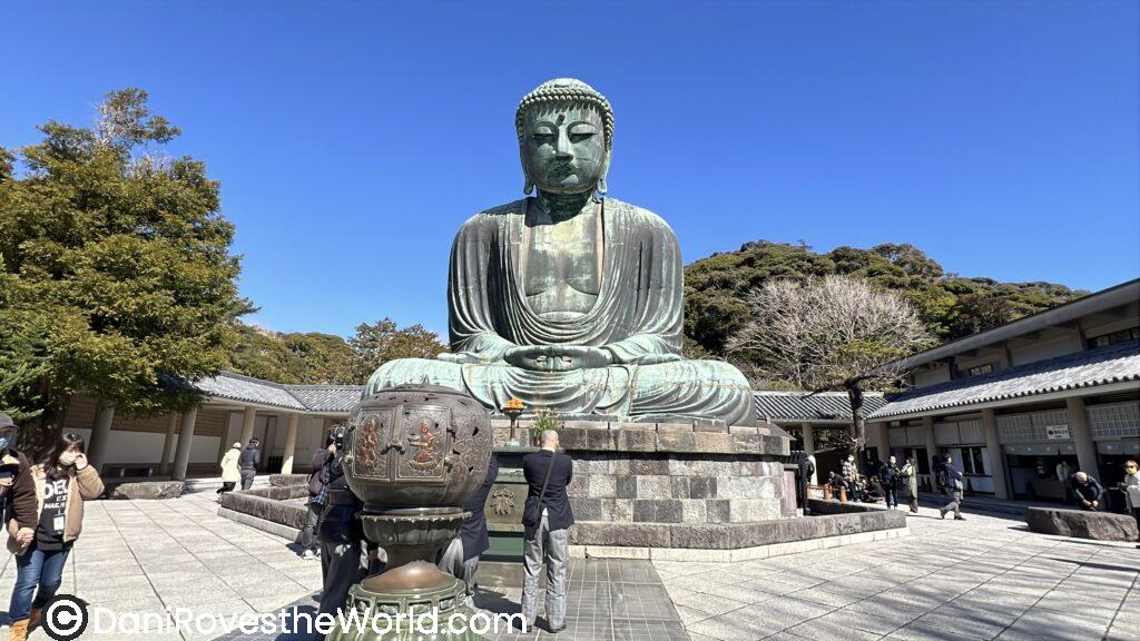 The Great Buddha of Kamakura, a massive bronze statue seated serenely under clear blue skies—one of the most iconic sights just a short train ride from Tokyo.
