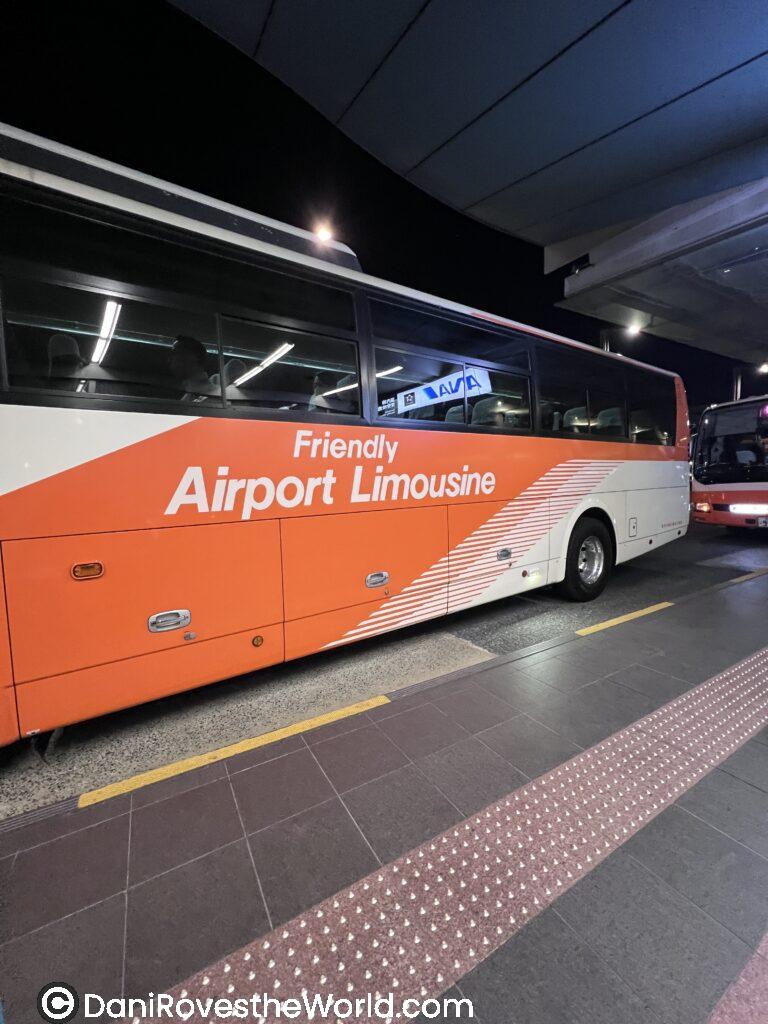 A Friendly Airport Limousine bus parked at the terminal, a convenient transfer option for how to get between Tokyo Airports and the city.