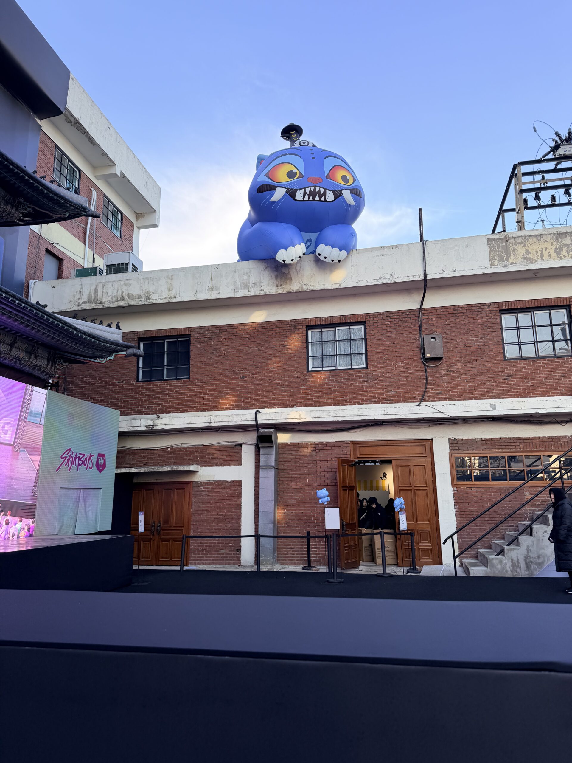 K Pop Demon Hunters pop up in seoul. Derby sits on top of a brick building in Seongsu